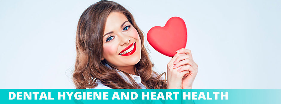 Dental hygiene and heart health — smiling woman holding red heart