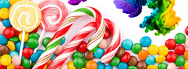 Brightly coloured sweets, candy canes and lollipops beside swirls of dye, from SANUSq Health on artificial food dyes