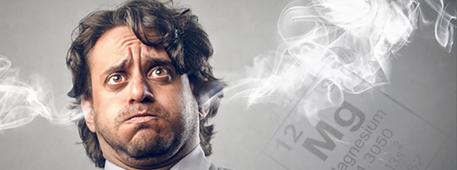 Stressed man with steam coming from his ears beside the magnesium element symbol, the calming mineral – SANUSq Health