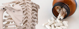 Skeleton model beside white calcium tablets spilling from a bottle, from SANUSq Health on the risks of too much calcium