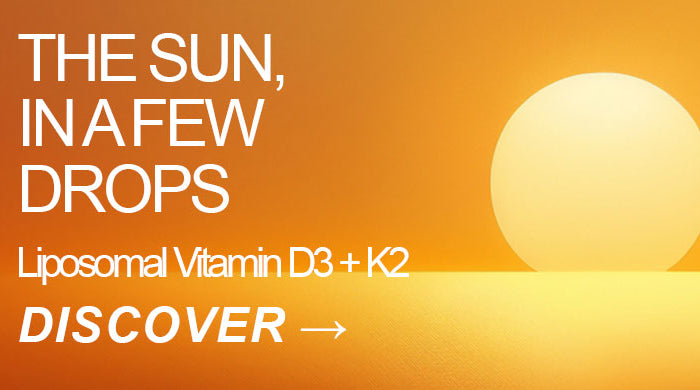 Liposomal vitamin D3 + K2 dropper bottle against a glowing orange sunset, the sun in a few drops – SANUSq Health