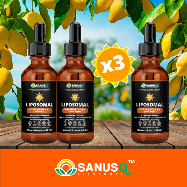 Three bottles of SANUSq Health liposomal Vitamin D3 + K2 vegan drops on a wooden table beneath sunny lemon branches